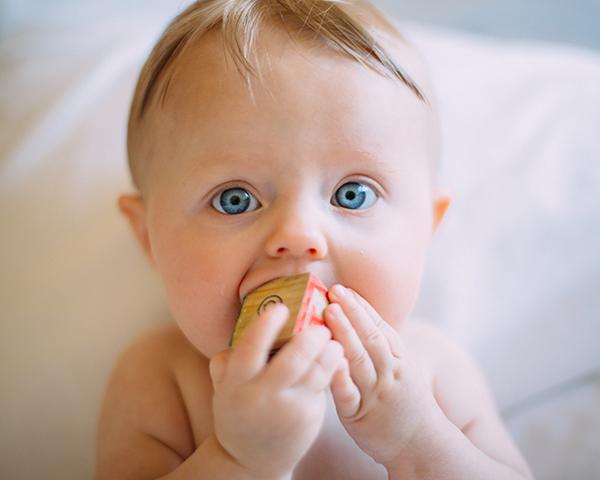 Baby chewing on a block, Pediatric dentist in Huntington Beach, CA