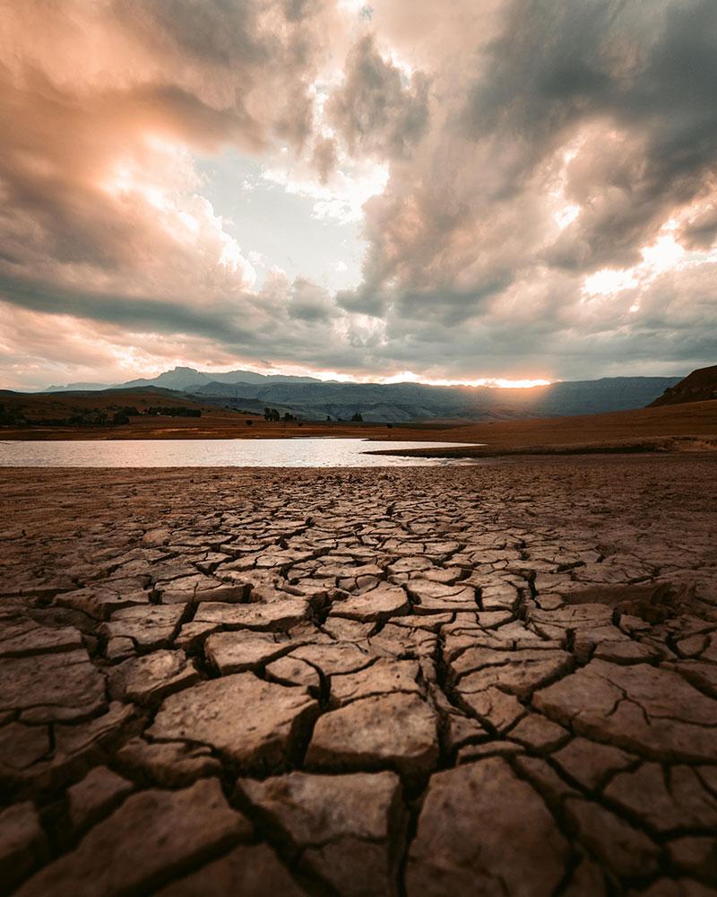 Dry dirt with water on the horizon 